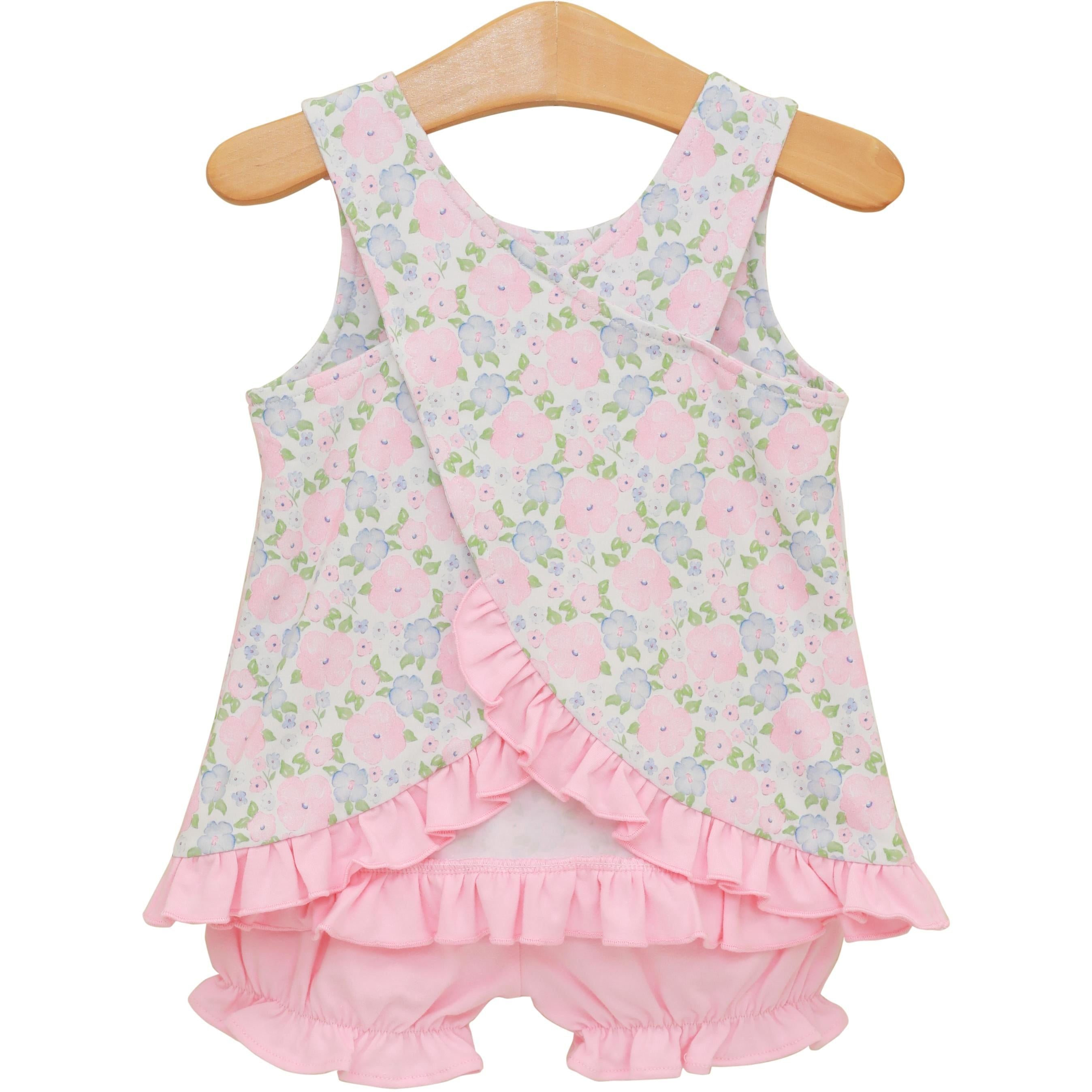 Baby girl's sleeveless floral print top with pink ruffled bloomers on wooden hanger
