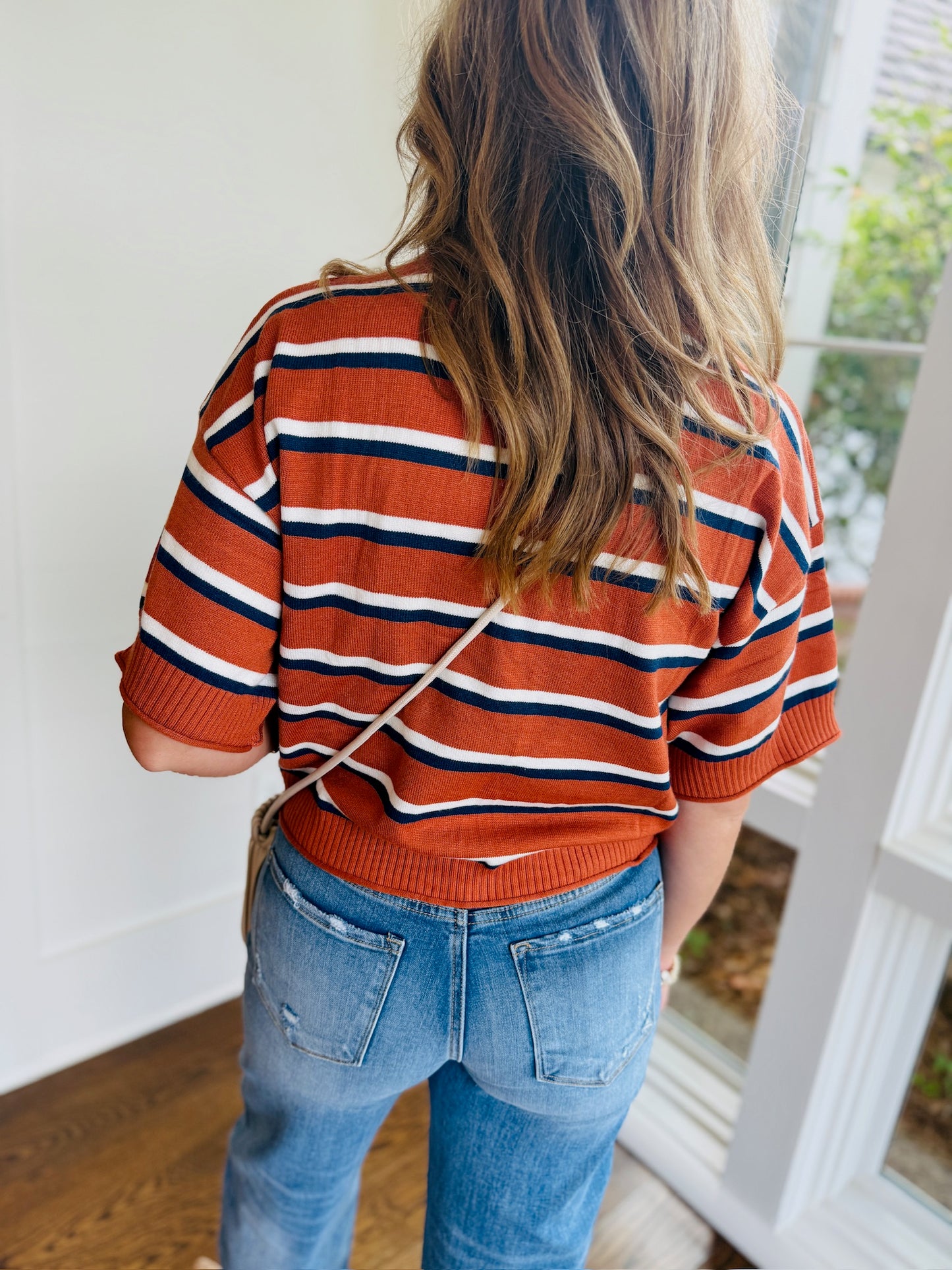 Side view of the Isabella striped short-sleeve knit top with jeans