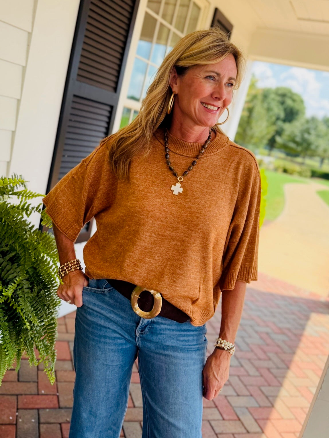 Close-up of the Mavis mocha short sleeve sweater top, showing the crew neckline, knit texture, and ribbed trim.
