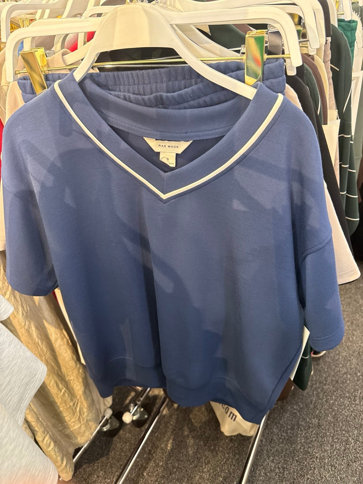 Smoky navy blue cropped V-neck sweatshirt top with cream trim detail, short sleeves.