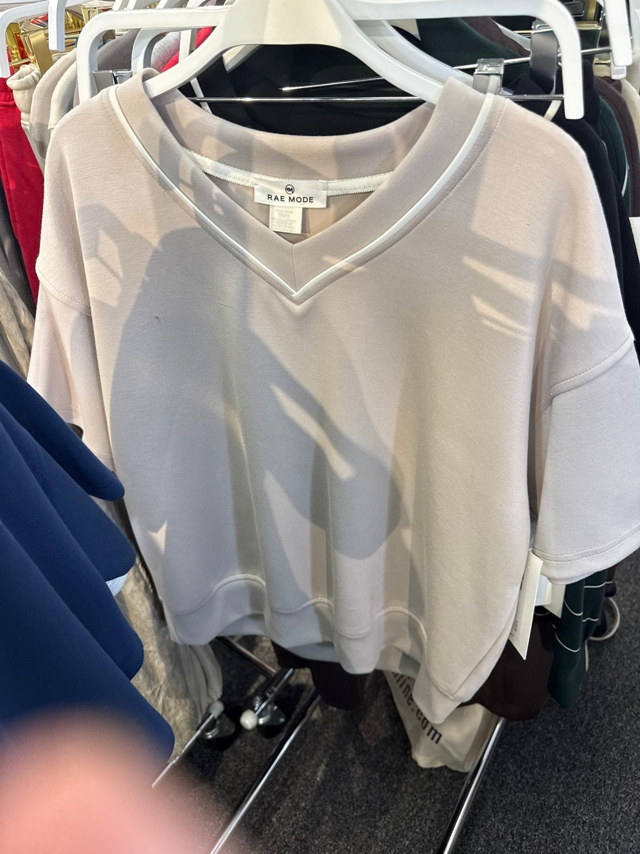 Rae Mode Gwendolyn oversized v-neck crop top in mocha cream with short sleeves on hanger.
