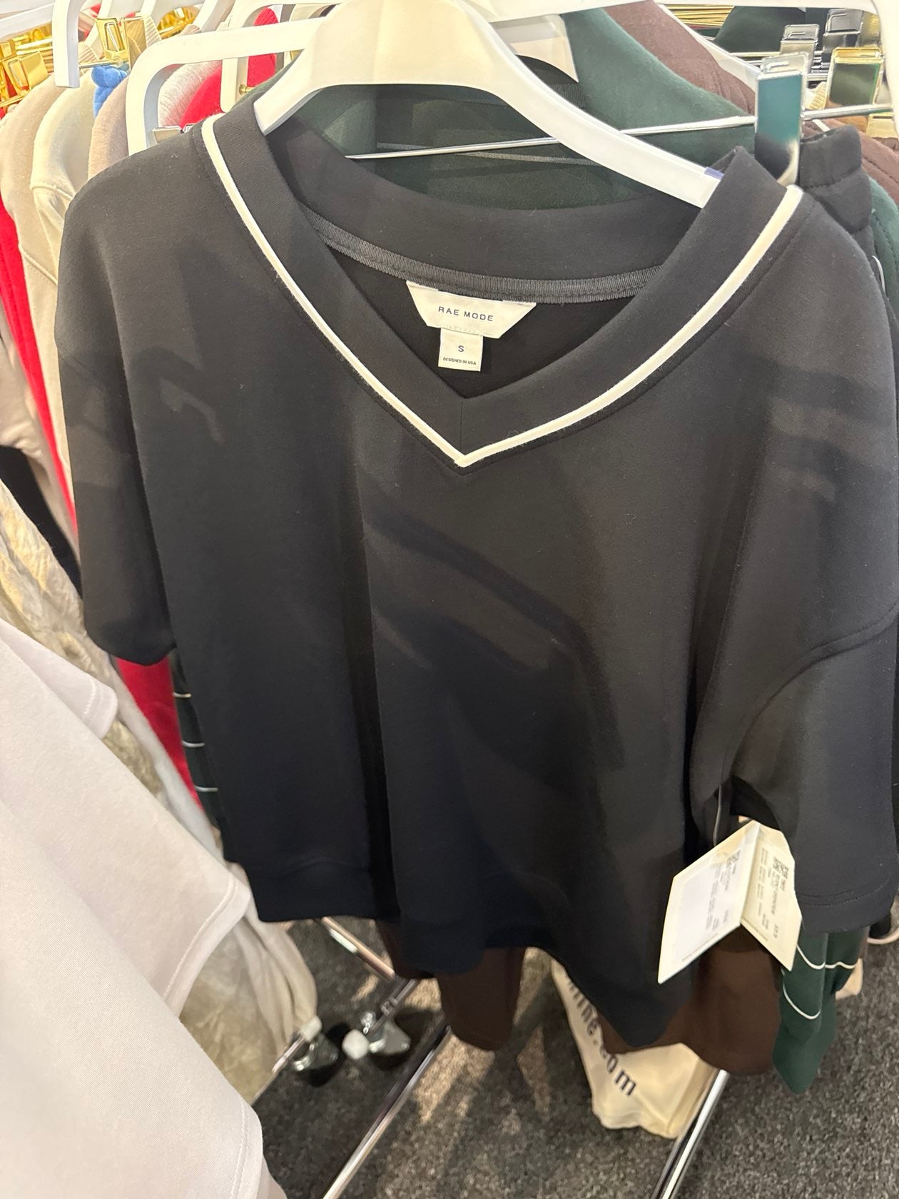 Black v-neck short sleeve top with cream trim detail by Rae Mode, size small, on hanger.