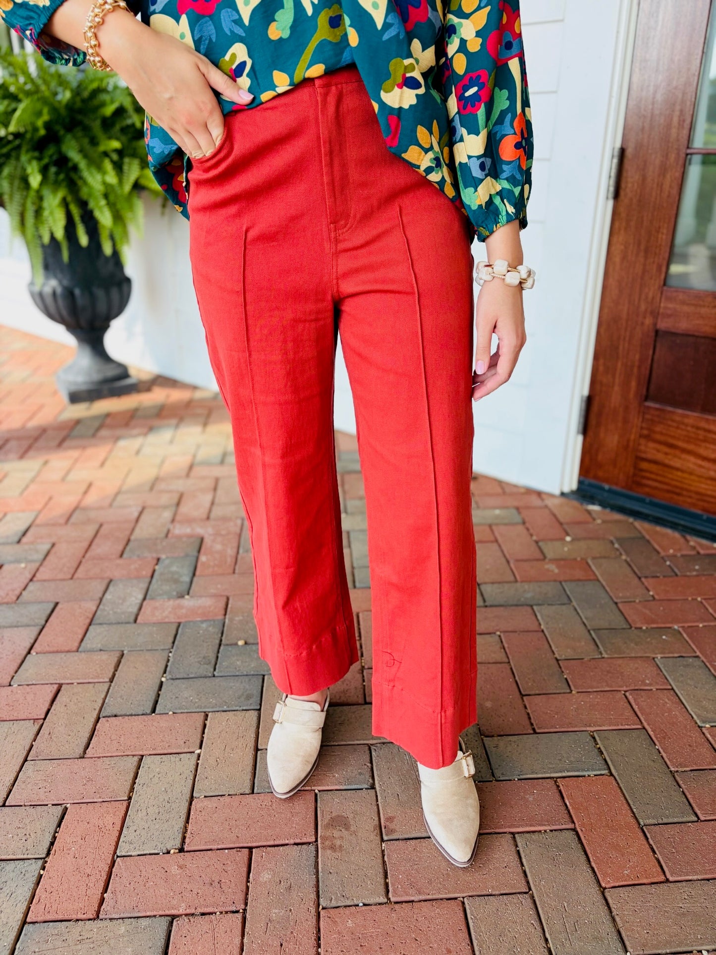 Close up of  the Rachel Seamed Front Pants, a rust red high waisted wide leg pant with front seam detail in soft stretch cotton. Sizes small to large. You will love the rusty red color for fall and winter!