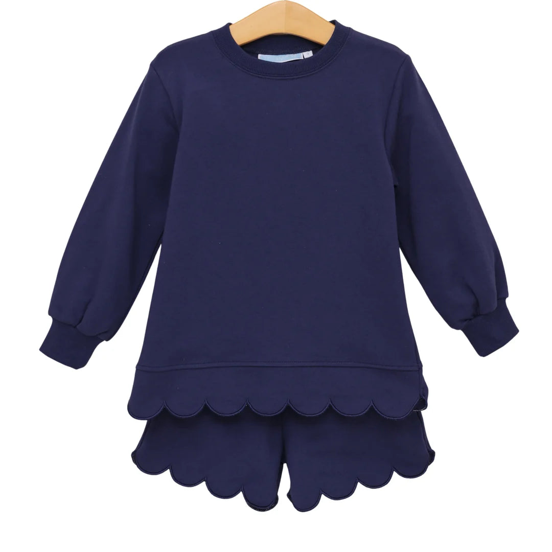 Navy blue children's matching sweatshirt and scalloped-hem shorts set on wooden hanger.
