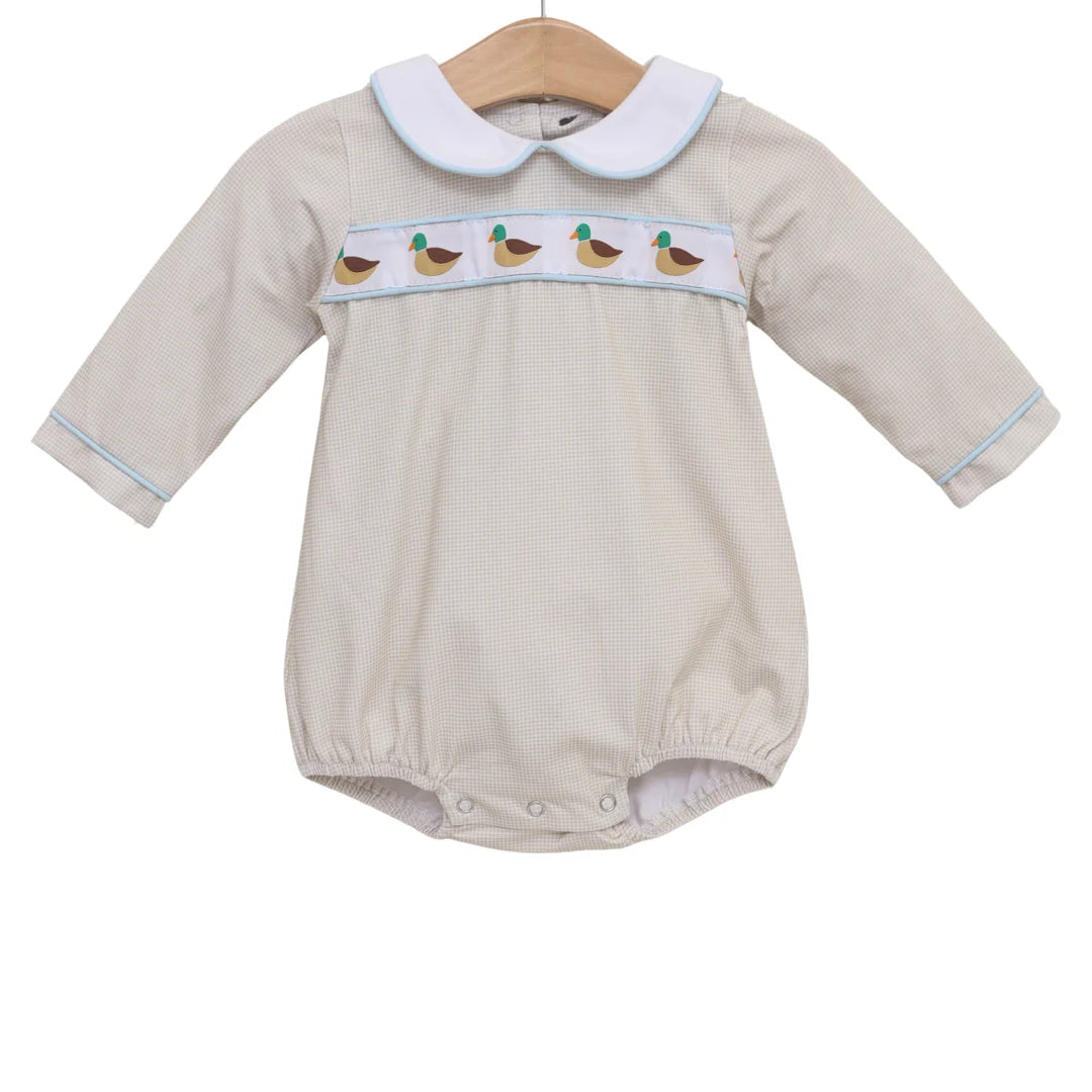 Tan gingham long-sleeve baby bubble romper with mallard duck embroidered chest band and white Peter Pan collar.