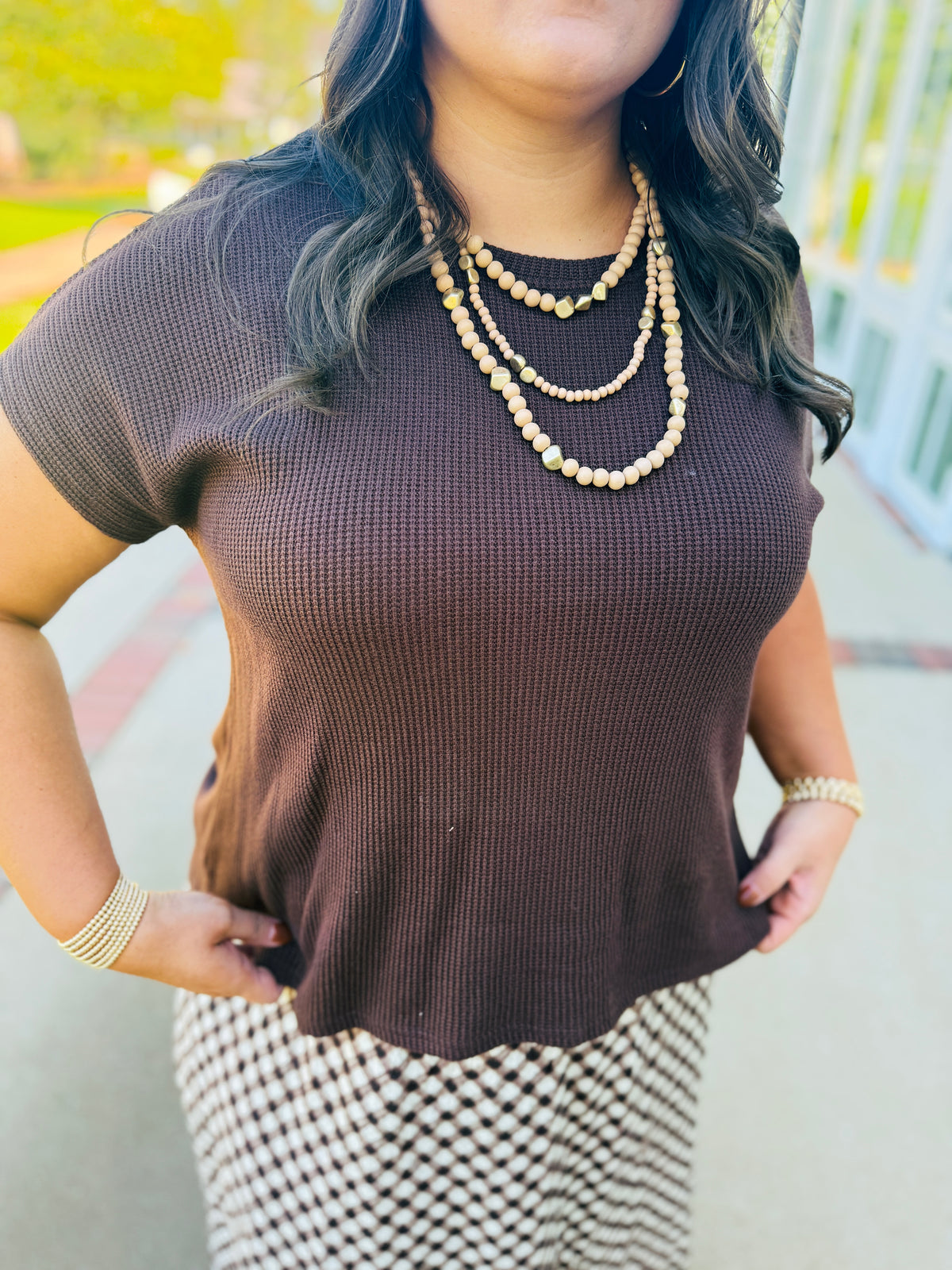 Close-up of the Ada brown top showing its waffle knit texture, round neckline and short sleeves.
