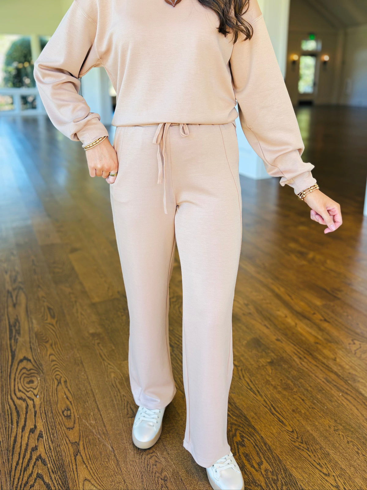Closer view of the Cassie dark taupe lounge pants showing their drawstring waist, side pockets and straight-leg silhouette.