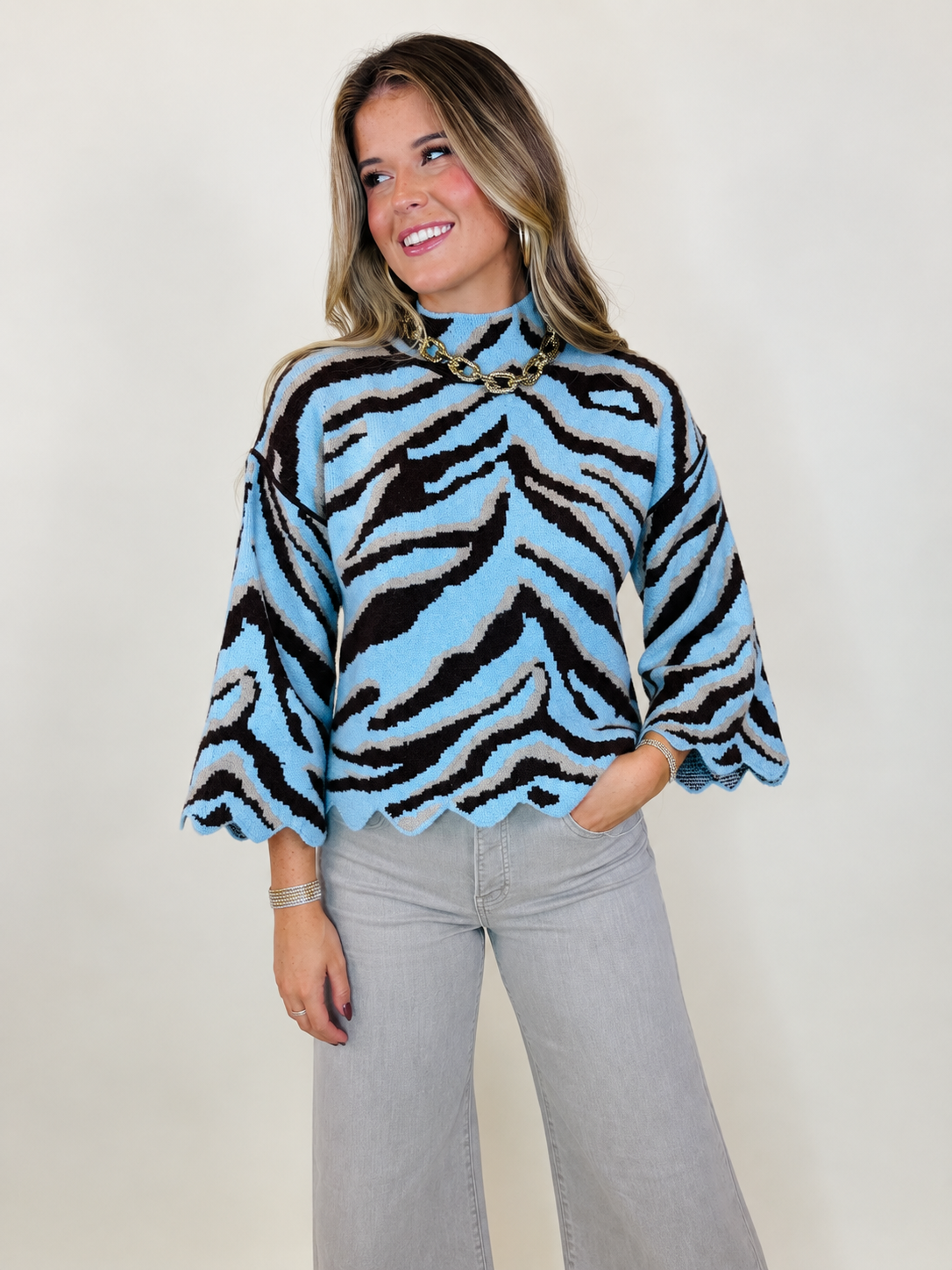 Model wearing the Chelsea light blue zebra sweater with the Beckett taupe wide-leg jeans.