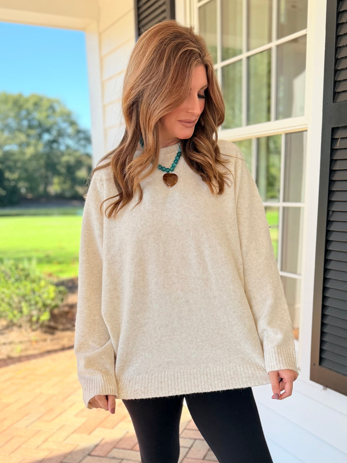 Closer view of the Corinna oatmeal crewneck sweater showing its soft knit texture, relaxed fit and ribbed trim.
