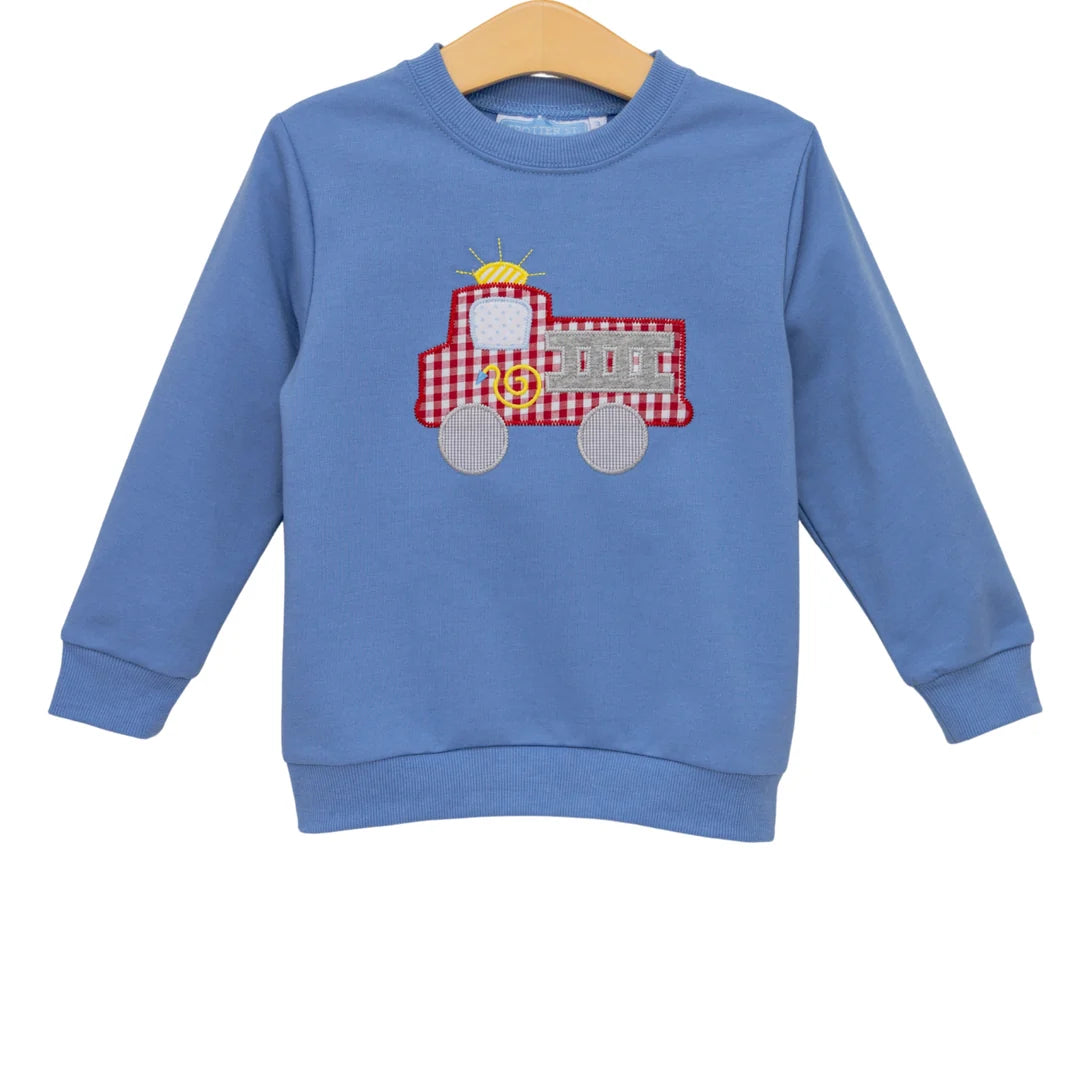 Blue long-sleeve French terry pullover sweatshirt with red gingham fire truck appliqué on chest.