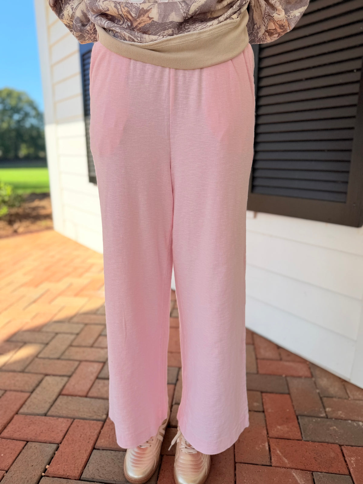 Close-up of the Della soft pink lounge pants showing their soft texture and relaxed wide-leg silhouette.