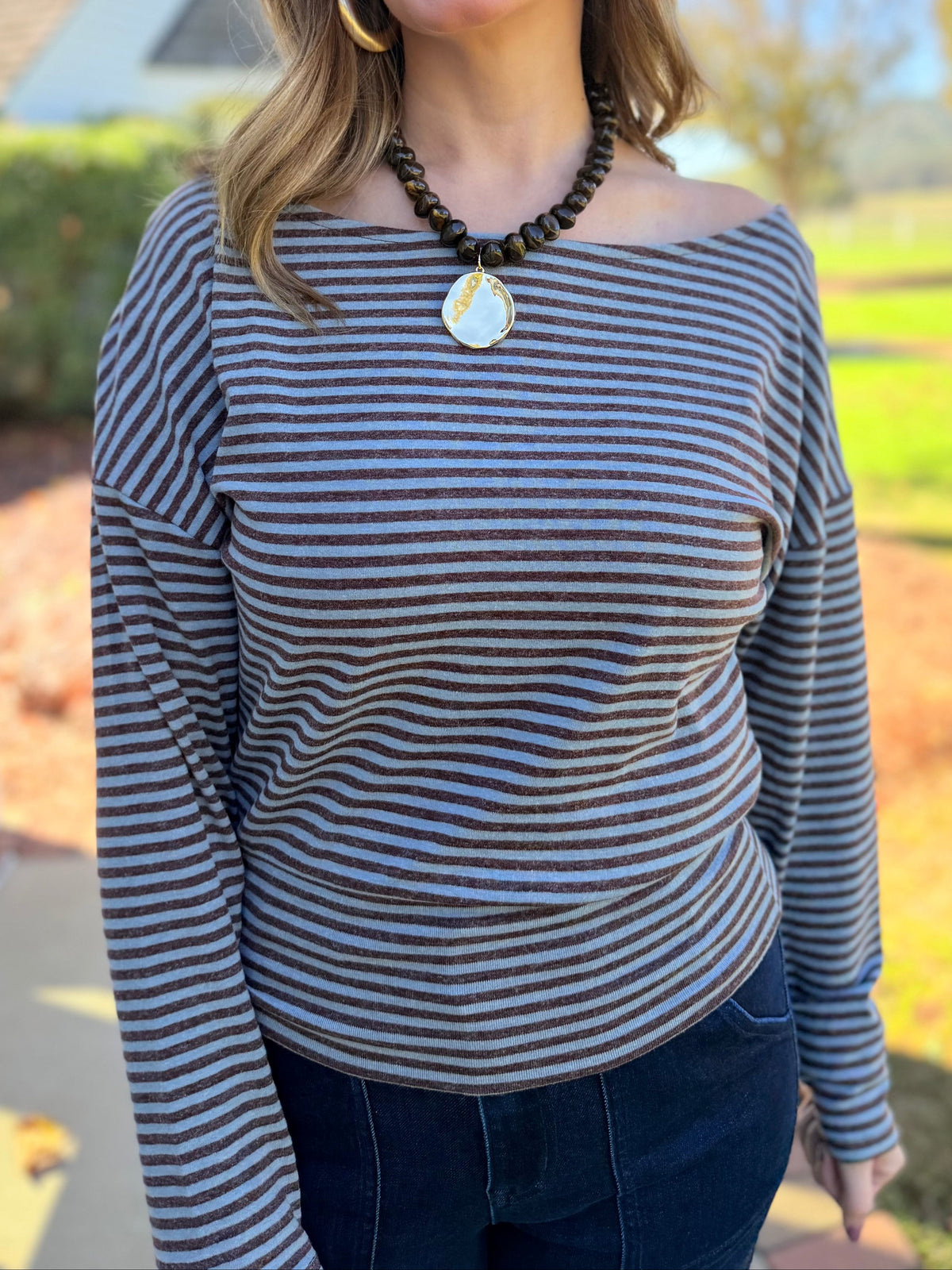 Close-up of the Elizabeth striped top showing its boat neckline, chocolate and blue stripes and soft stretch fabric.