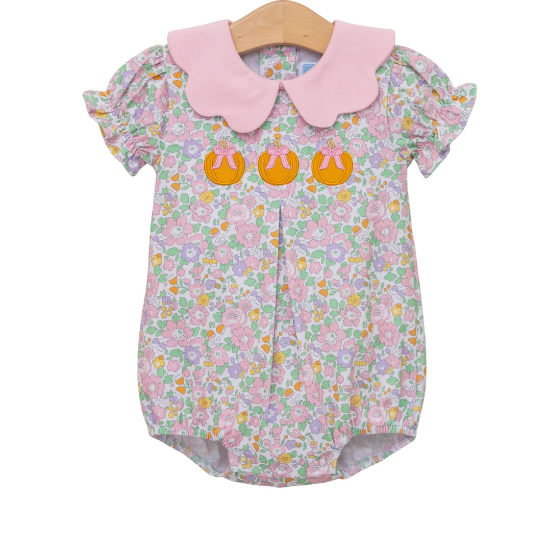 Baby girl floral bubble romper with pink Peter Pan collar and three embroidered pumpkin appliqués.