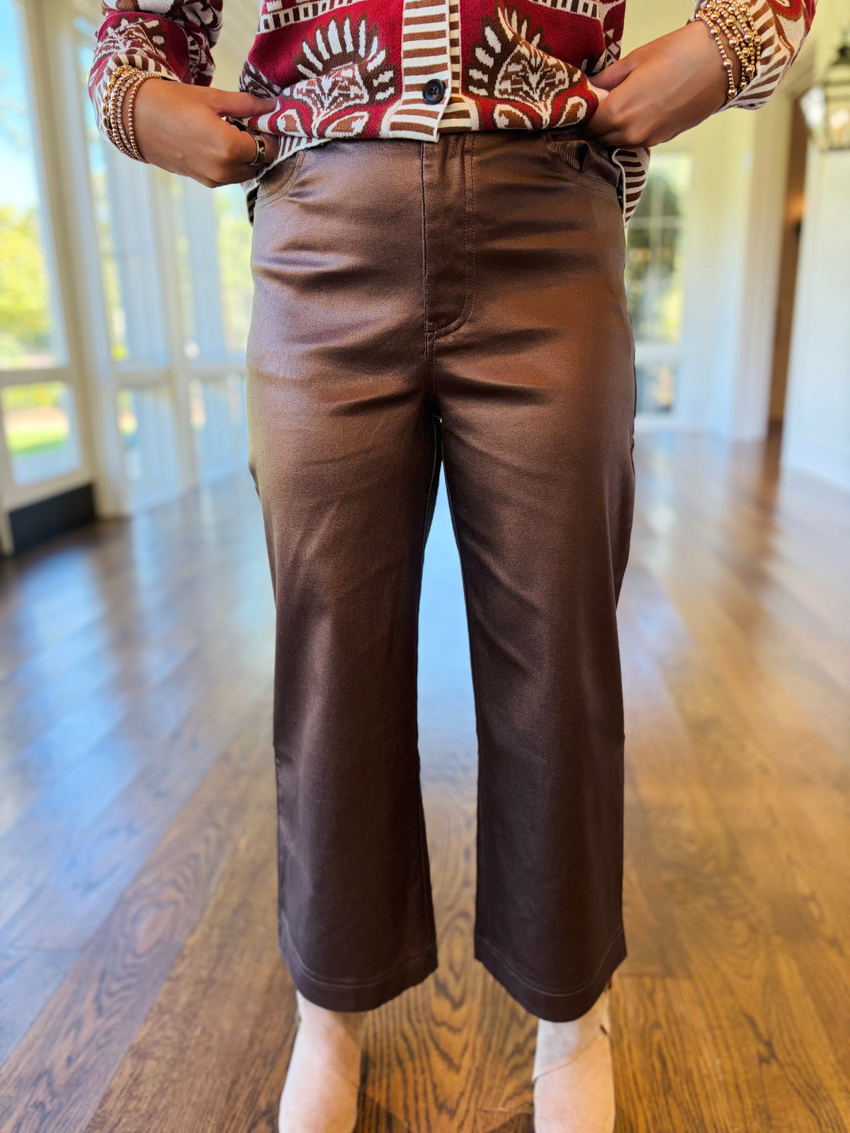Close-up of the Florence metallic brown wide-leg pants showing the high-rise waist, smooth finish and cropped silhouette.