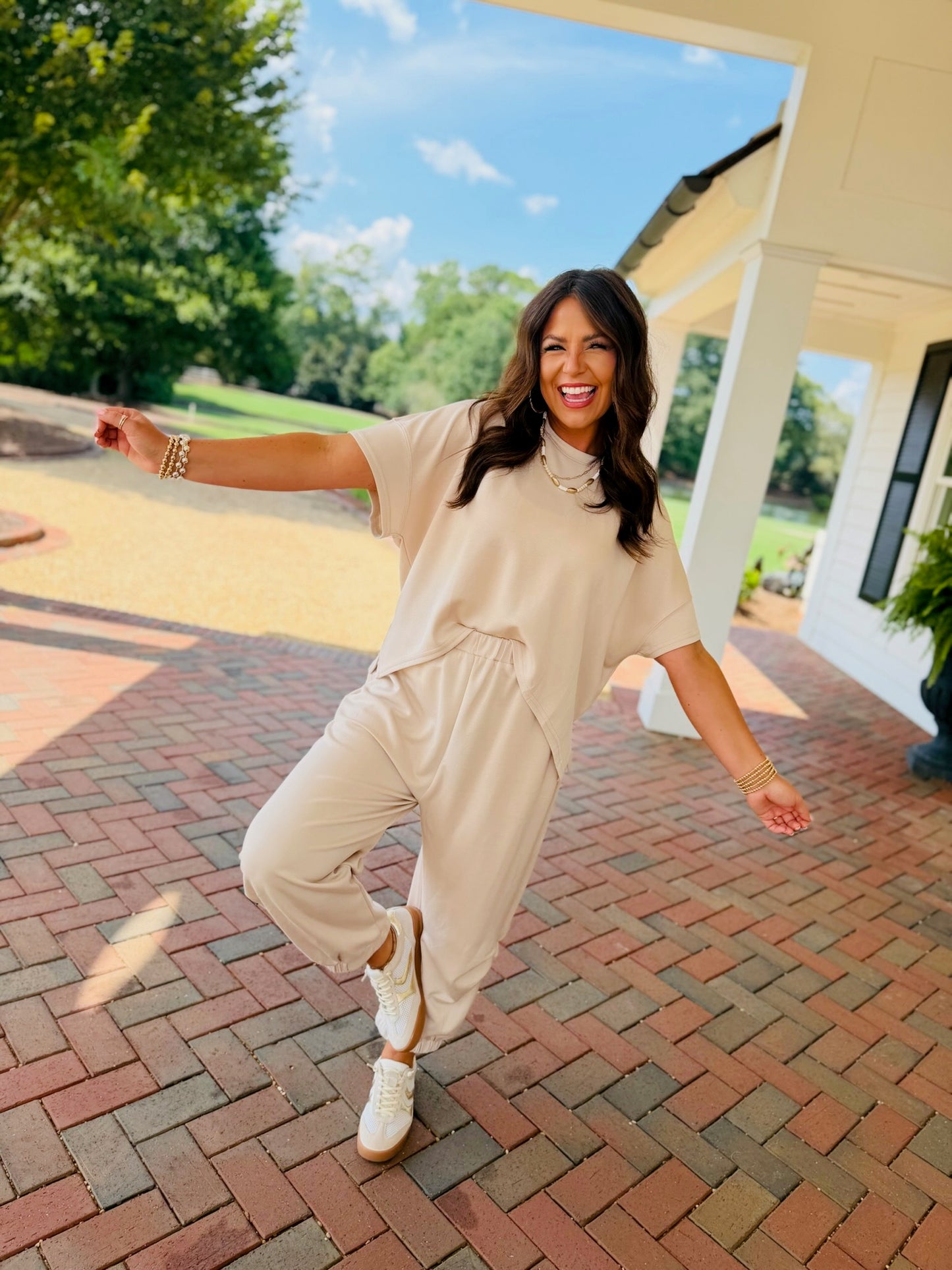 Woman wearing the Hannah beige butter soft lounge set with a relaxed short sleeve top and wide leg drawstring pants