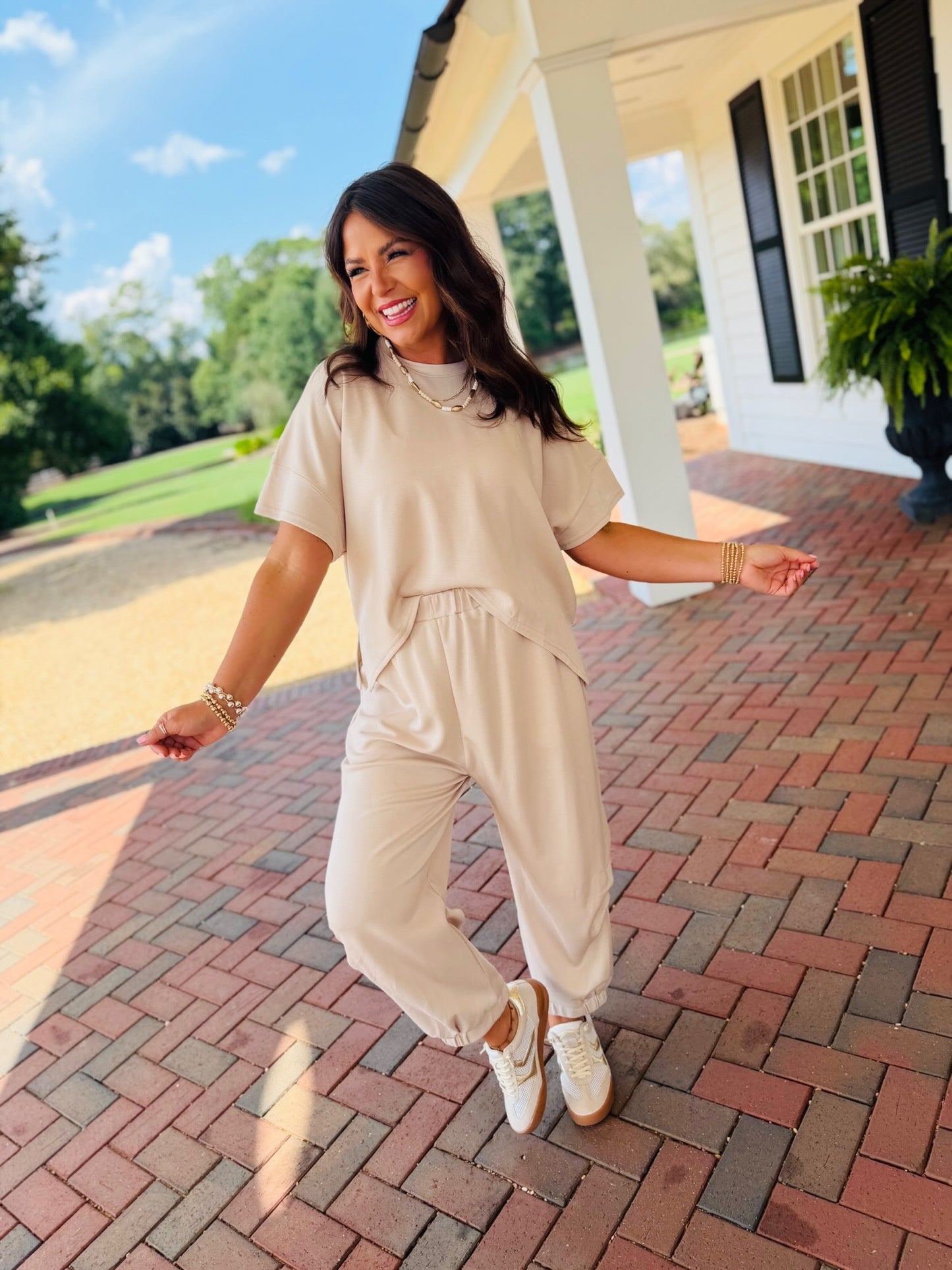 Side view of the Hannah beige butter soft lounge set styled with white sneakers for a casual weekend outfit