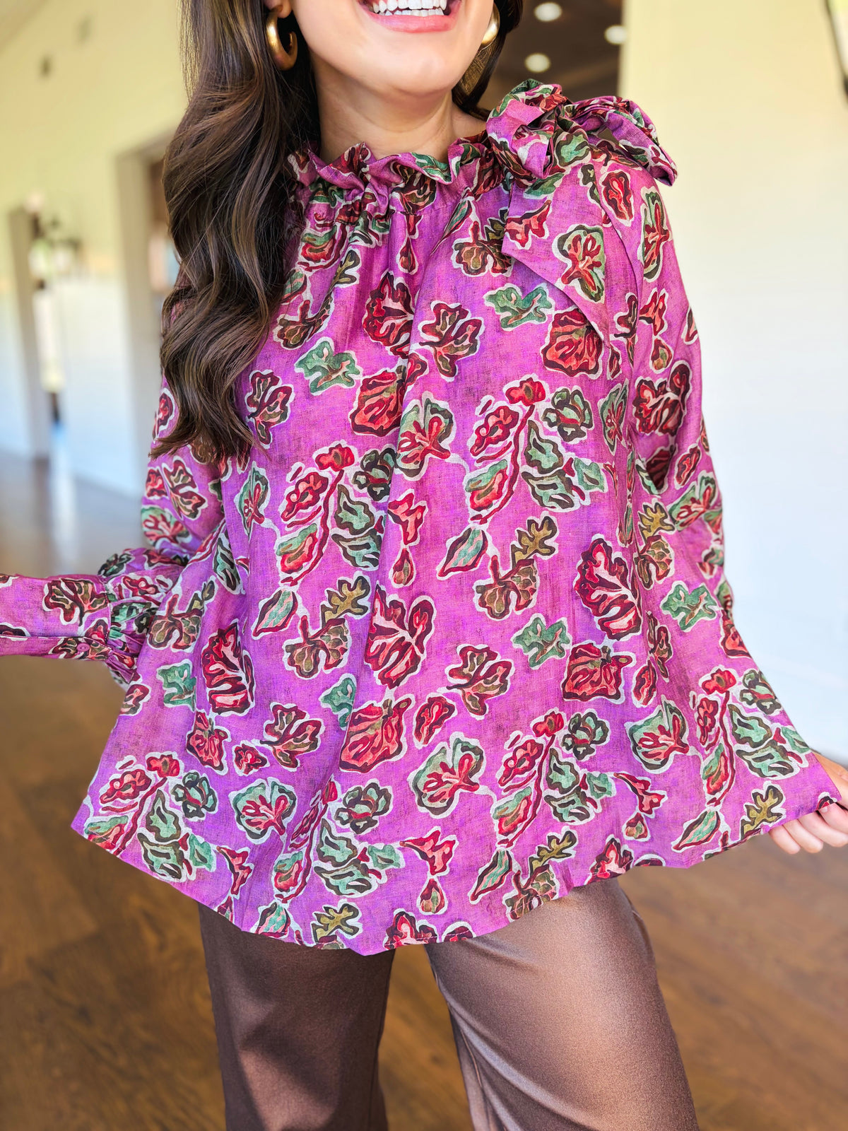 Closer view of the Harper pink floral blouse showing its ruffled neckline, shoulder detailing and multicolor print.