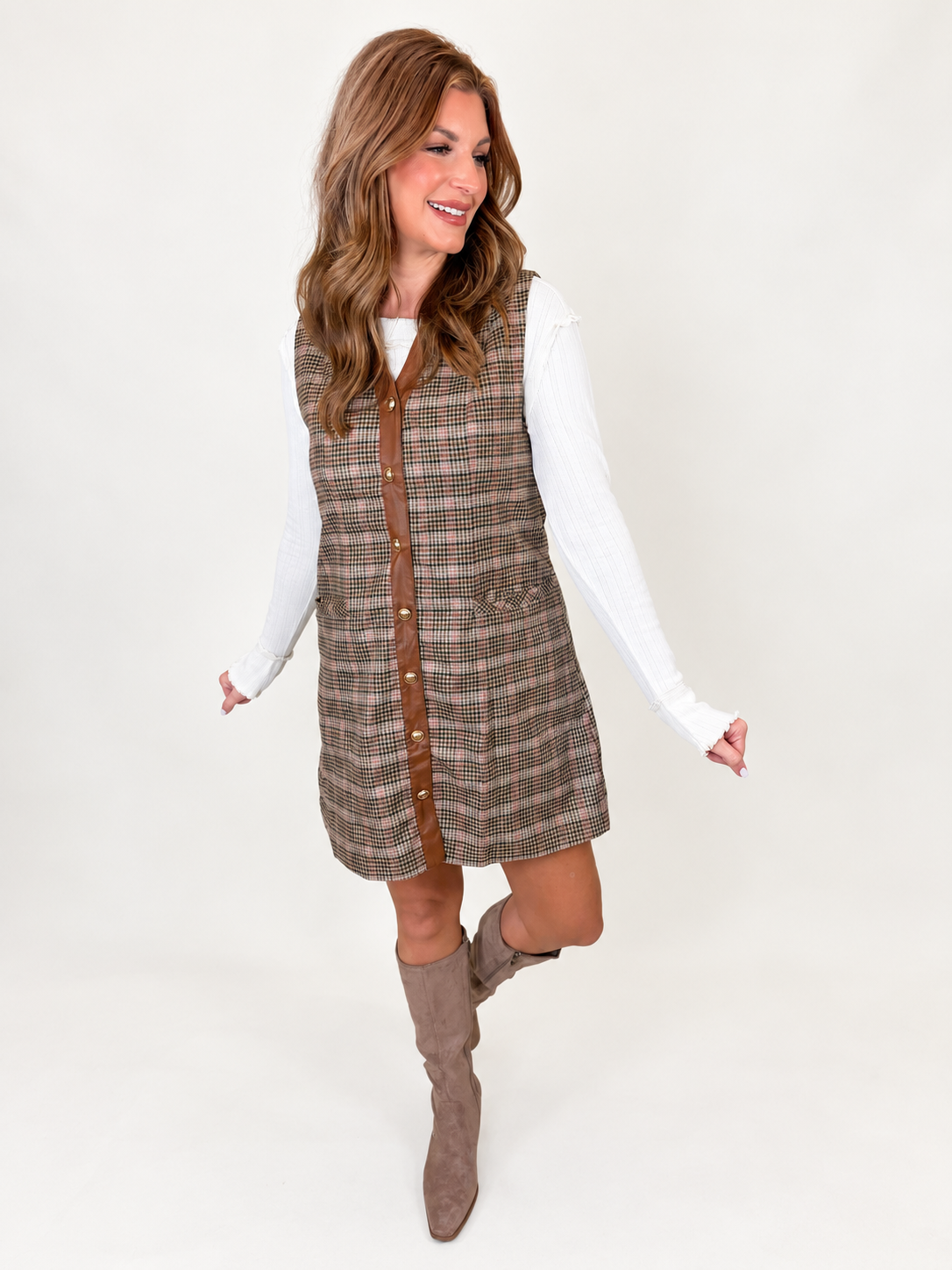 Angled front view of the Heaven taupe plaid mini dress showing its brown contrast trim, button front and patch pockets.