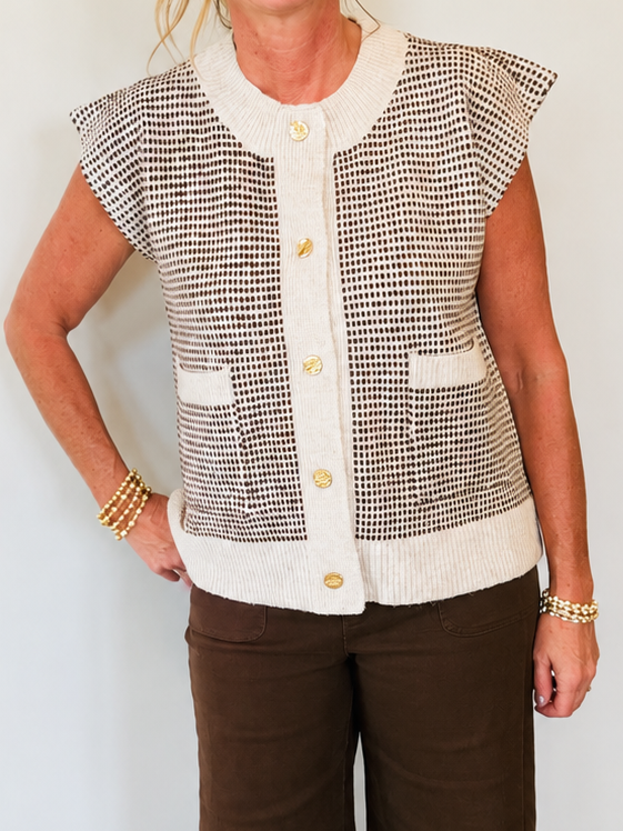 Close-up of Kelly wearing the Hillary oatmeal houndstooth cropped vest with cream trim and gold buttons