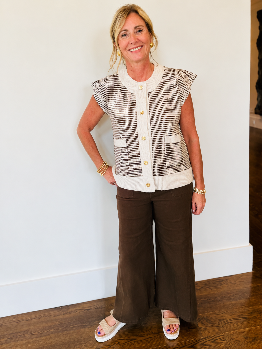 Kelly wearing the Hillary oatmeal houndstooth cropped vest with brown wide-leg pants and white sandals