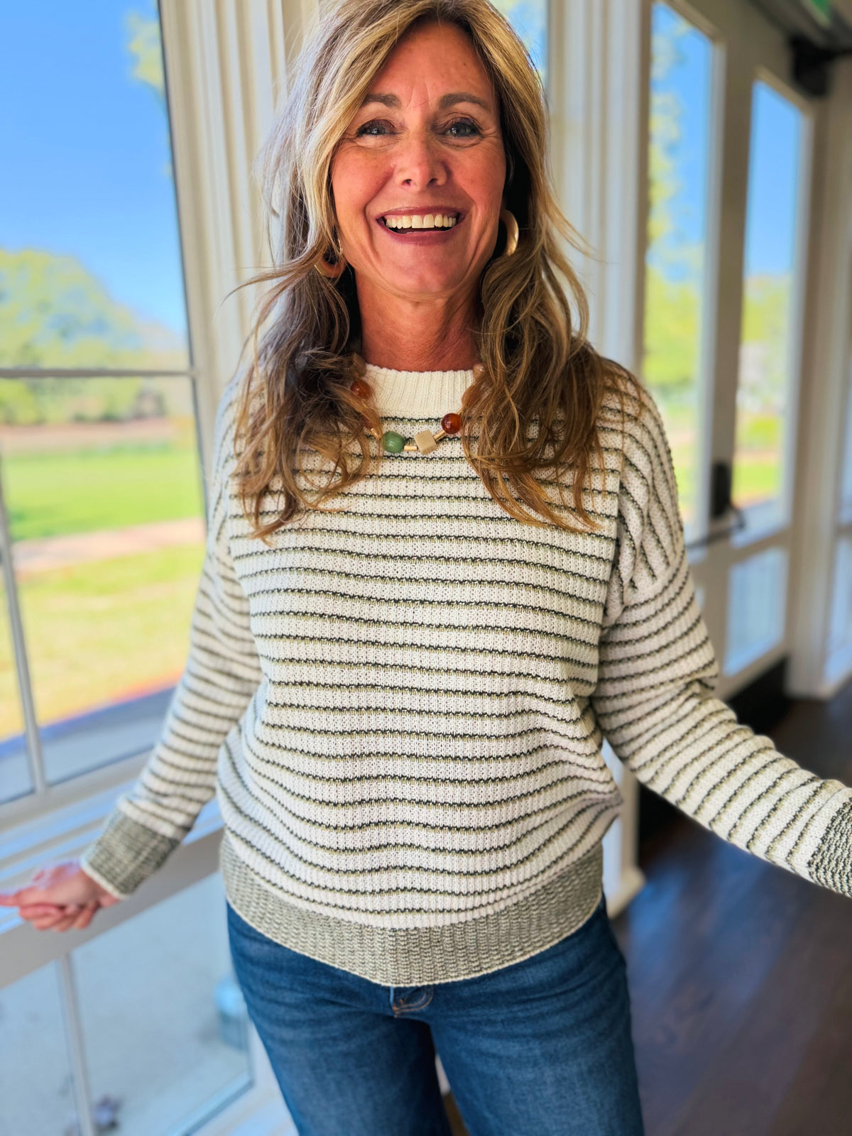 Closer view of the Hollis olive striped knit sweater showing its crew neckline, horizontal stripes and ribbed trim.