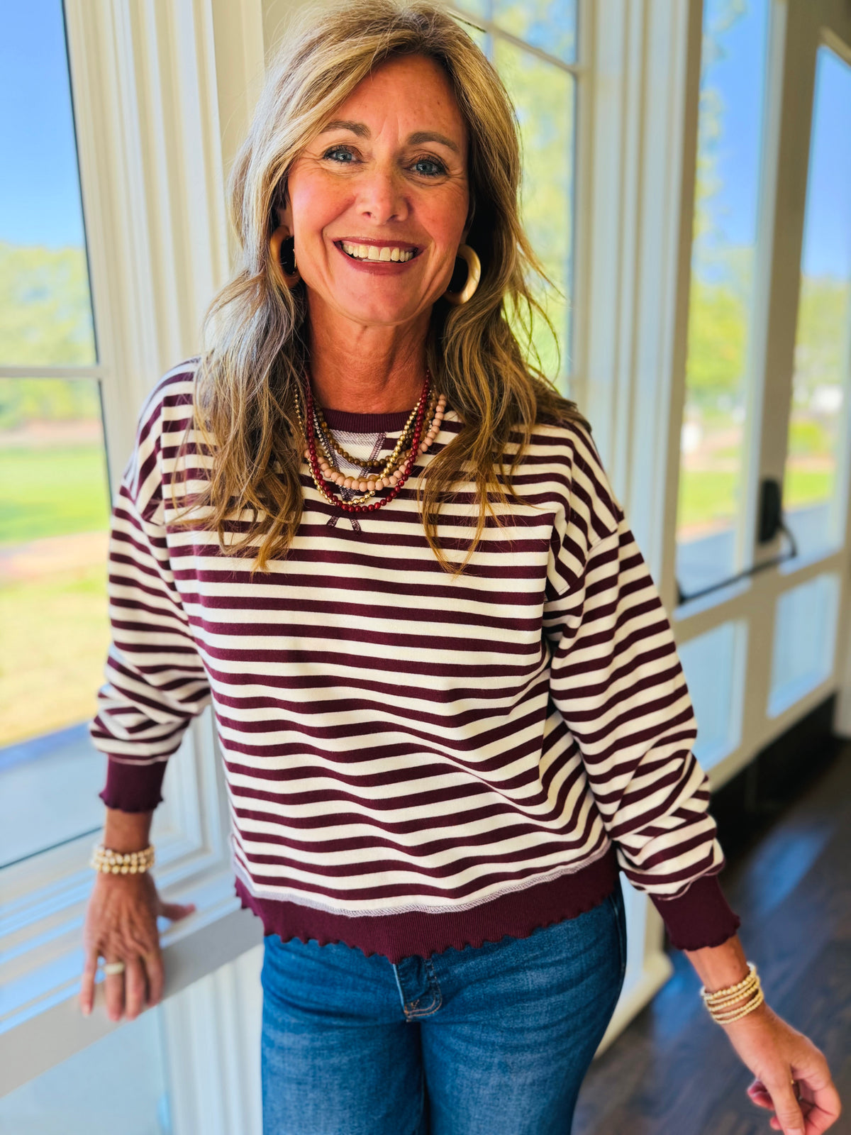 Closer view of the Jazlyn burgundy mix sweatshirt showing its horizontal stripes, crew neckline and ribbed trim.
