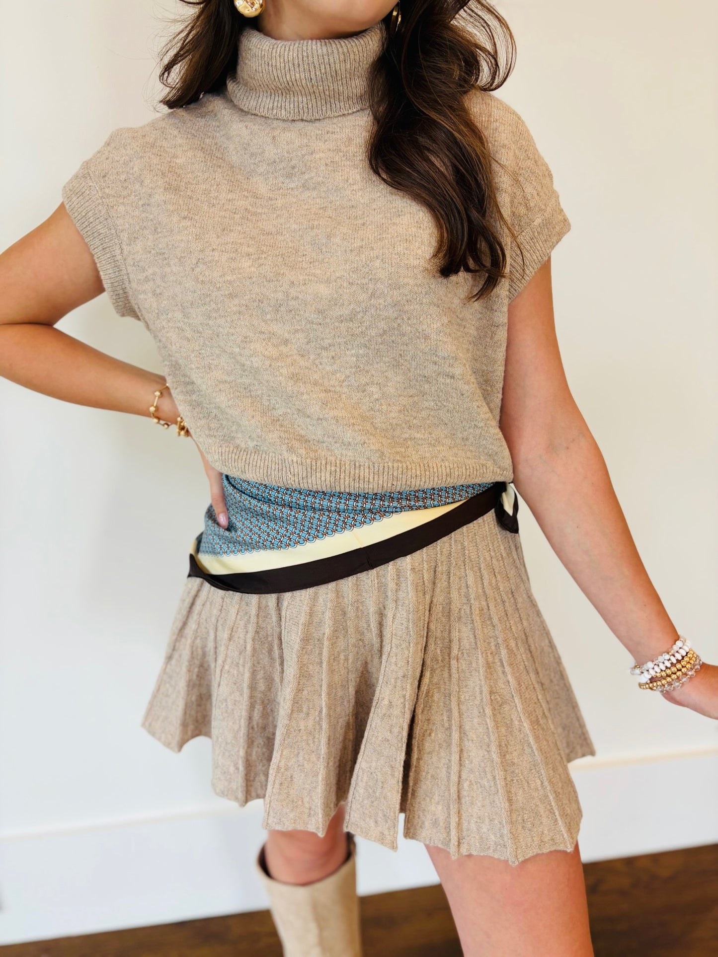 Front detail of Lacey wearing the dark taupe knit top and pleated skirt set with contrast striped trim
