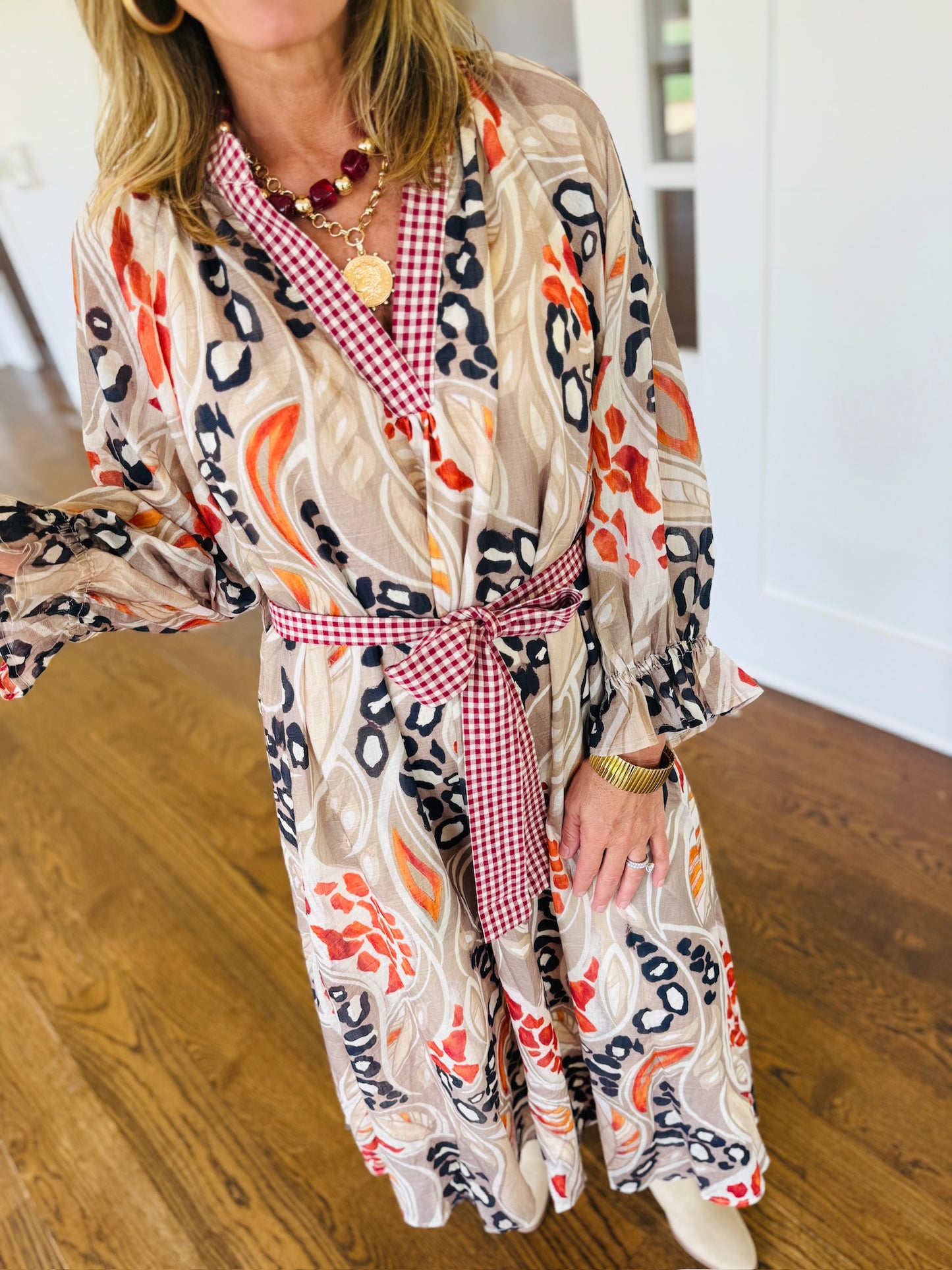 Close-up of Ginny wearing the Melody mocha abstract floral maxi dress showing the V-neckline and print