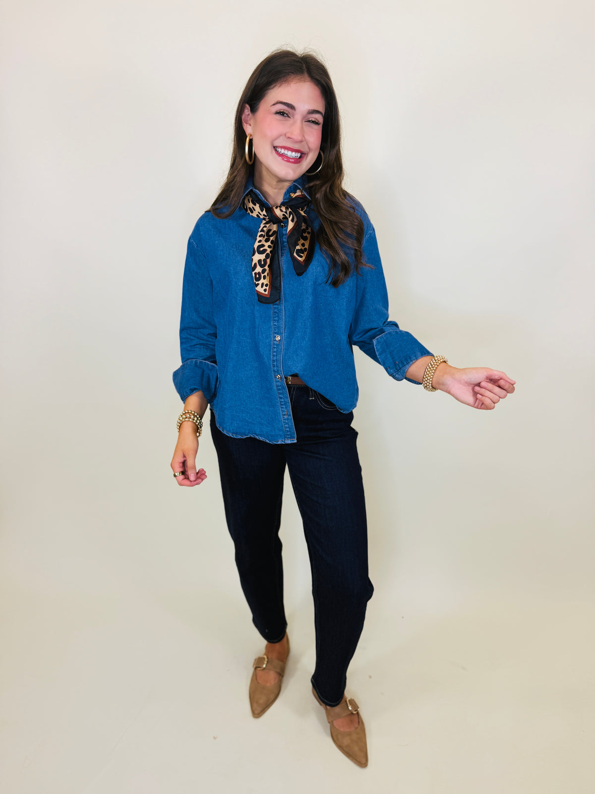Lacey wearing the Reese denim button-up shirt with dark jeans, a leopard-print neck scarf and brown flats.