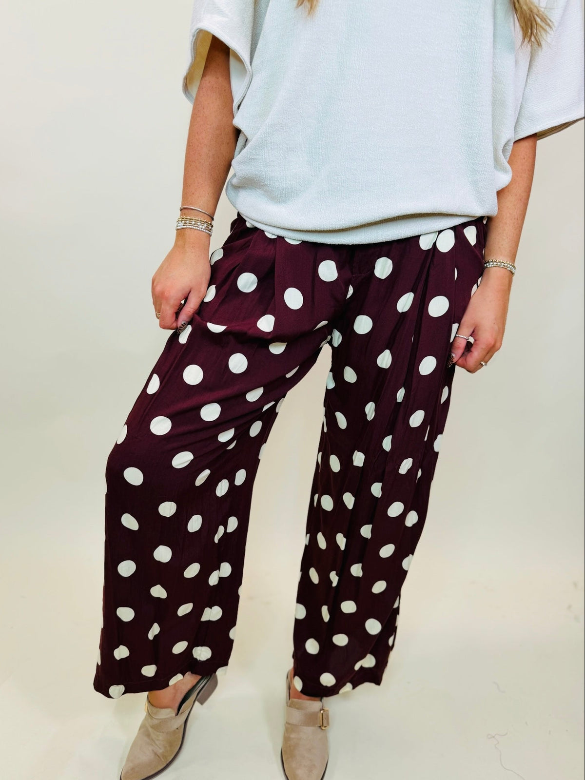 Ella wearing The Rue wine polka-dot wide-leg pants with an elastic waist and side pockets