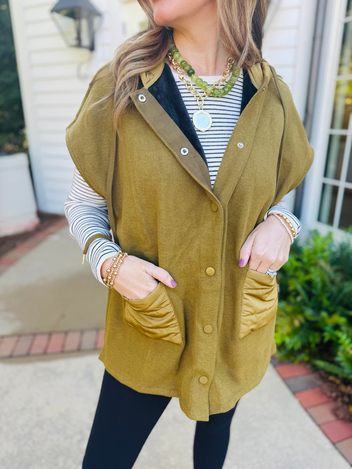 Closer view of the Winnie moss hooded jacket showing its snap front, contrast trim and quilted patch pockets.